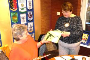 Helen handing over Rotary regalia